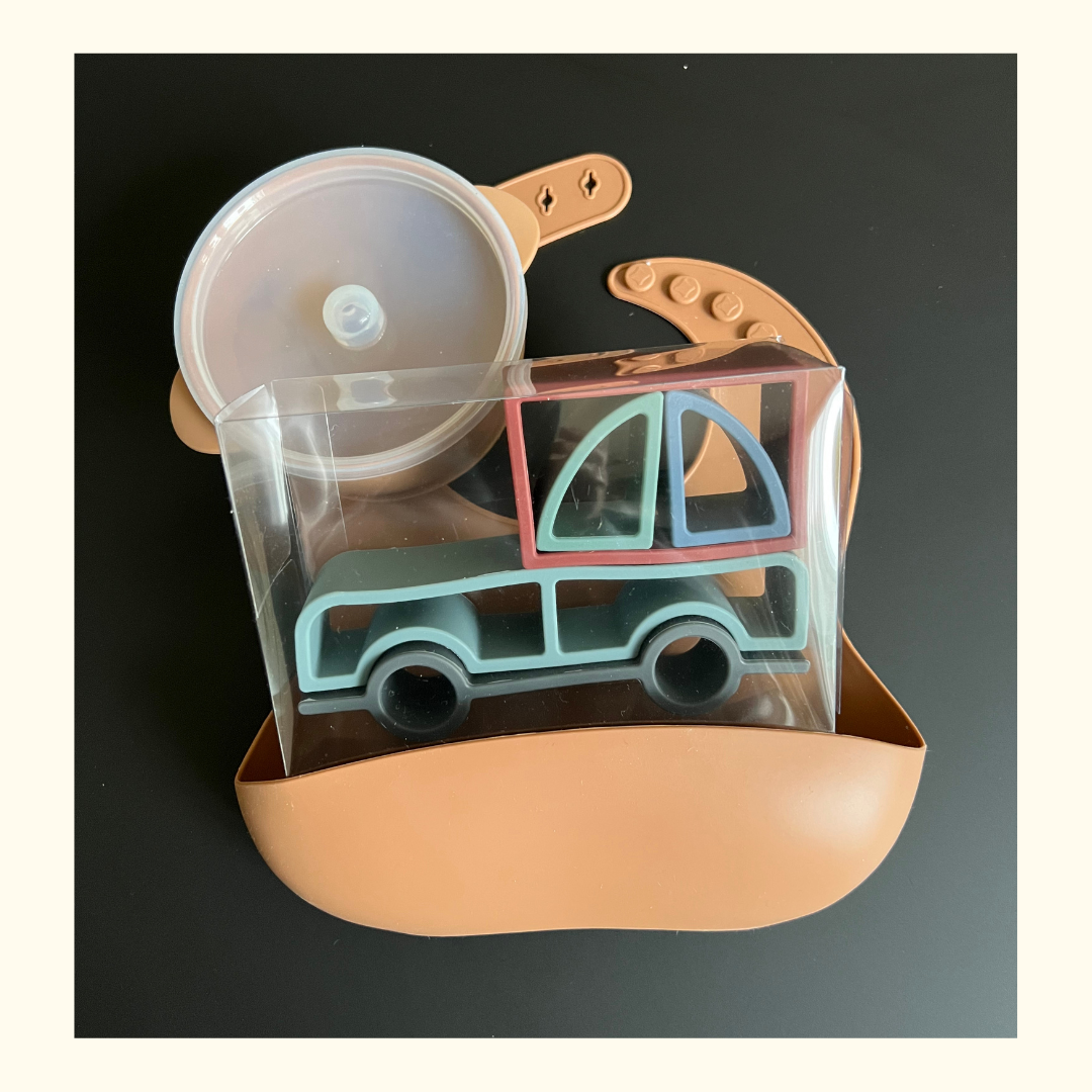 baby gift set. clay silicone bib with food catcher, suction bowl and lid with toddler truck stacker toy