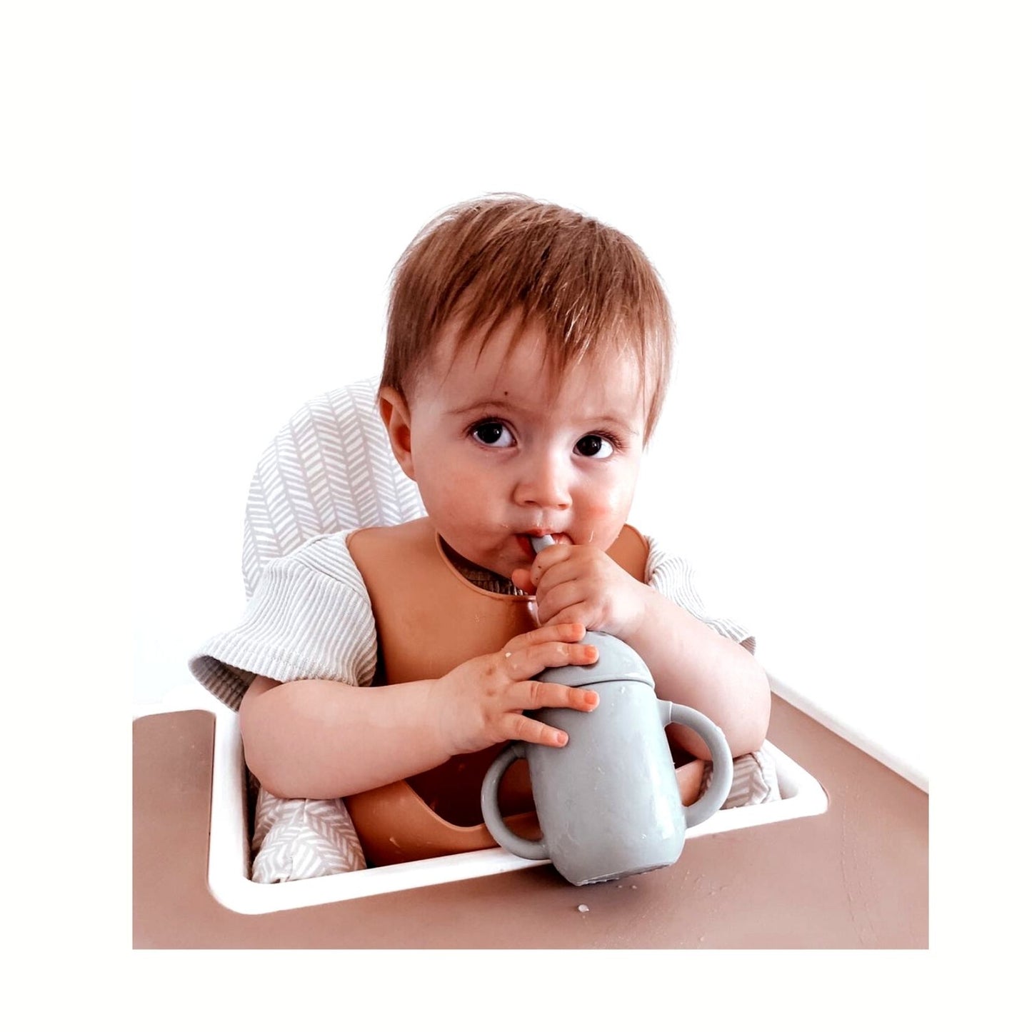 toddler with sage sippy cup and clay silicone bib with food catcher pocket